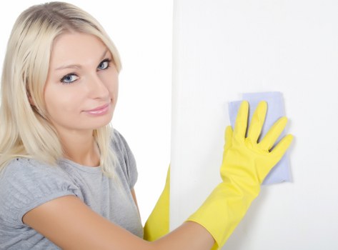 Domestic cleaners in Roehampton vacuuming and tidying a bright living room